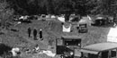 cars and campers in a meadow in yosemite valley.